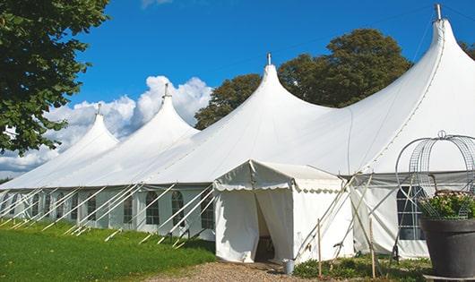 a row of blue portable restrooms waiting to be used at a special event in Lyndhurst